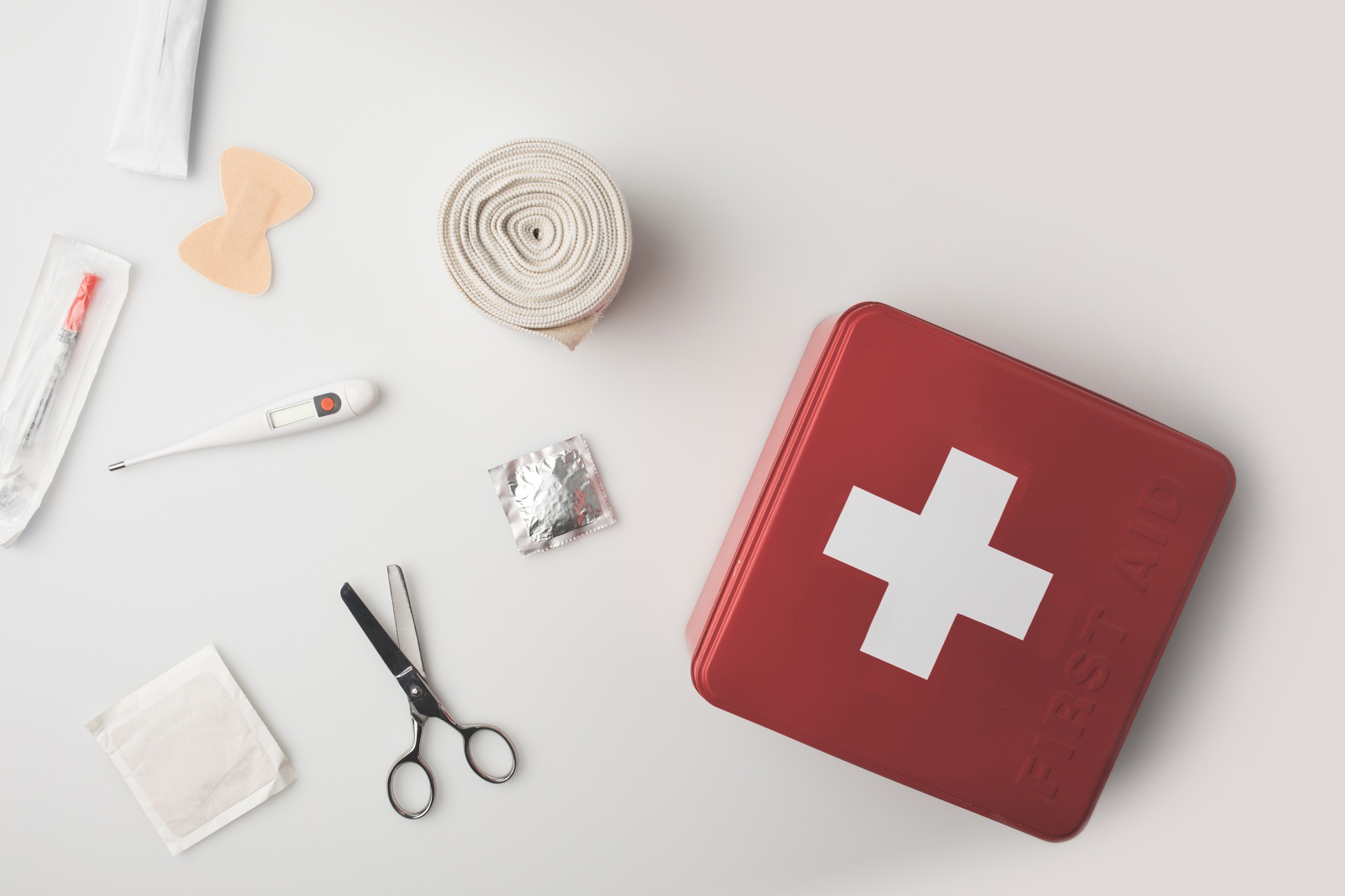 Top view first-aid kit with medical supplies isolated on white